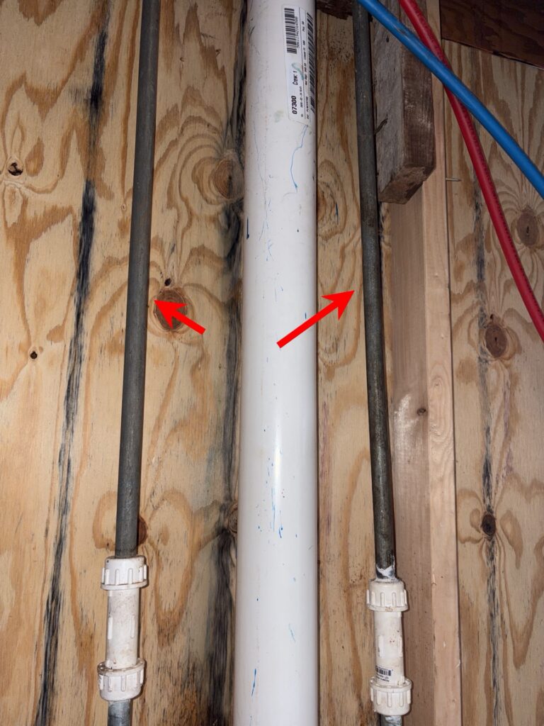 Corroded galvanized plumbing flagged during an investment property inspection