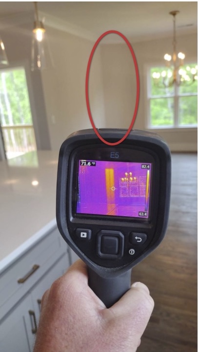 Thermal image revealing a temperature anomaly inside a wall cavity during an Ally home inspection